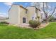 This home features a backyard with grass, plants, and rock features at 10520 W Fair Ave # A, Littleton, CO 80127