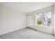 Bright bedroom with a large window and mirrored closet doors at 10520 W Fair Ave # A, Littleton, CO 80127