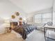 Comfortable bedroom with a large window providing natural light at 10520 W Fair Ave # A, Littleton, CO 80127