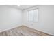 Bedroom with wood-look vinyl flooring and window at 10520 W Fair Ave # A, Littleton, CO 80127