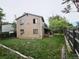 A view of the fenced backyard showcasing a two-story home with a deck at 4677 S Salida St, Aurora, CO 80015