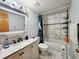 Neat bathroom with updated vanity, marble backsplash, and shower-tub combination at 4677 S Salida St, Aurora, CO 80015