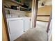 Laundry area with washer, dryer and shelving for ample storage near carpeted bedroom at 4677 S Salida St, Aurora, CO 80015