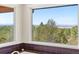 Bathroom window showcasing stunning mountain views at 8544 Burning Tree Trl, Franktown, CO 80116