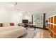 Bright bedroom features a large window, wooden floors, and an office space at 8544 Burning Tree Trl, Franktown, CO 80116