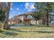 Two-story home with a landscaped yard, portico, and a beautiful brown tile roof at 8544 Burning Tree Trl, Franktown, CO 80116