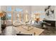 Stylish living room with large windows offering views and a cozy seating area at 8544 Burning Tree Trl, Franktown, CO 80116