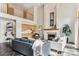 Open concept living area boasts high ceilings, a fireplace, and comfortable seating, perfect for relaxation at 8544 Burning Tree Trl, Franktown, CO 80116