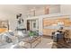 Spacious living room with a fireplace, wet bar, and large windows at 8544 Burning Tree Trl, Franktown, CO 80116