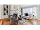 Cozy living room with a fireplace, comfortable seating, and large windows, creating an inviting ambiance at 8544 Burning Tree Trl, Franktown, CO 80116