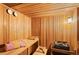 Relaxing wooden sauna with benches, heater, and lighting for a spa-like experience at home at 8544 Burning Tree Trl, Franktown, CO 80116