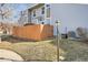 Backyard exterior with wooden fence, light post, green grass, and partial view of exterior at 8391 W 90Th Pl # 101, Westminster, CO 80021