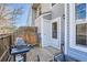 Backyard patio area with wooden deck, gas grill, wooden fence, and partial view of exterior at 8391 W 90Th Pl # 101, Westminster, CO 80021