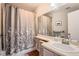 Bathroom with decorative shower curtain, and vanity sink with neutral walls, cabinets, and hardwood floor at 8391 W 90Th Pl # 101, Westminster, CO 80021