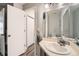Bathroom featuring a vanity with mirror, open doorway, and storage closet nearby at 8391 W 90Th Pl # 101, Westminster, CO 80021