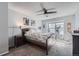 Bright bedroom featuring a ceiling fan, neutral walls, carpeted floors, and a comfortable bed at 8391 W 90Th Pl # 101, Westminster, CO 80021