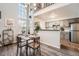 Bright dining area with high ceilings, modern chandelier, and view of kitchen at 8391 W 90Th Pl # 101, Westminster, CO 80021