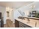 Bright kitchen area with stainless dishwasher and view to staircase and Gathering room at 8391 W 90Th Pl # 101, Westminster, CO 80021