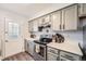 Traditional kitchen features white countertops, grey cabinets, and stainless steel appliances at 8391 W 90Th Pl # 101, Westminster, CO 80021