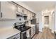 Traditional kitchen features white countertops, grey cabinets, and stainless steel appliances at 8391 W 90Th Pl # 101, Westminster, CO 80021