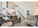 Spacious living room with high ceilings, staircase, open floor plan, and view to bedroom at 8391 W 90Th Pl # 101, Westminster, CO 80021