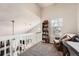 Relaxing loft area with cozy chair and a view to the downstairs living room at 8391 W 90Th Pl # 101, Westminster, CO 80021