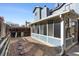 Backyard featuring a sunroom attached to the house and a gravel area with pavers at 10470 W 83Rd Ave, Arvada, CO 80005