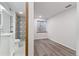 Modern bathroom features a decorative tiled shower, vanity with sink, and wood-look flooring at 10470 W 83Rd Ave, Arvada, CO 80005