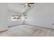 Bright, large bedroom featuring neutral carpet, vaulted ceilings, and large windows at 10470 W 83Rd Ave, Arvada, CO 80005