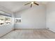 Bright bedroom with a high ceiling, fan, neutral carpet, and two windows allowing natural light at 10470 W 83Rd Ave, Arvada, CO 80005