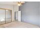 Bedroom with a mirrored closet and neutral walls and carpet, offering a comfortable and simple design at 10470 W 83Rd Ave, Arvada, CO 80005
