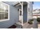 Side entrance featuring a white door and concrete steps, providing a welcoming entry at 10470 W 83Rd Ave, Arvada, CO 80005