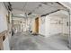 Spacious garage featuring open shelving, concrete floor, and a door leading inside the home at 10470 W 83Rd Ave, Arvada, CO 80005