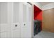Laundry room with a washer, dryer, storage closet, and a door leading to another room at 10470 W 83Rd Ave, Arvada, CO 80005