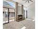 Living room featuring a brick fireplace and sliding glass door entry to the sunroom at 10470 W 83Rd Ave, Arvada, CO 80005
