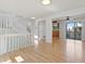 Hardwood floor in living room with a staircase and view of the kitchen and sunroom entrance at 10470 W 83Rd Ave, Arvada, CO 80005