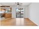 Living room with hardwood floors, a ceiling fan, and a sliding glass door to the outside at 10470 W 83Rd Ave, Arvada, CO 80005