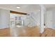 Open living room with hardwood floors, a staircase, and a view of the fireplace at 10470 W 83Rd Ave, Arvada, CO 80005