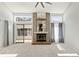 Spacious living room features a brick fireplace and sliding glass door entry to the sunroom at 10470 W 83Rd Ave, Arvada, CO 80005
