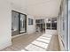 Sunroom featuring white walls, tile floor and glass doors leading to the backyard at 10470 W 83Rd Ave, Arvada, CO 80005
