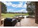 Relaxing backyard patio seating with lush green golf course views and pond and trees at 3216 Country Club Pkwy, Castle Rock, CO 80108
