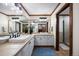 Bright bathroom with double sinks, custom cabinets, and wood trim at 3216 Country Club Pkwy, Castle Rock, CO 80108