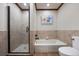Bright bathroom features tiled shower, soaker tub and stylish finishes at 3216 Country Club Pkwy, Castle Rock, CO 80108