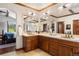 Bathroom with double sink vanity, granite countertop, wood cabinets, and tiled floors at 3216 Country Club Pkwy, Castle Rock, CO 80108