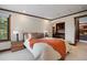 Bedroom with wood trim and built in desk, a modern bed frame, wood bedside tables, and great natural light at 3216 Country Club Pkwy, Castle Rock, CO 80108