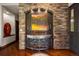 Beautiful foyer featuring hardwood floors, stone archway, and a decorative console table and painting at 3216 Country Club Pkwy, Castle Rock, CO 80108