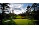 Picturesque golf course featuring lush greenery, a sand trap, and a serene pond for a tranquil golfing experience at 3216 Country Club Pkwy, Castle Rock, CO 80108