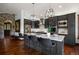 Contemporary kitchen with dark cabinets, stainless appliances, a spacious island with bar seating, and tile backsplash at 3216 Country Club Pkwy, Castle Rock, CO 80108