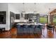 Stylish kitchen featuring dark cabinets, hardwood floors, stainless steel appliances, and a large island at 3216 Country Club Pkwy, Castle Rock, CO 80108
