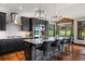 Modern kitchen with dark cabinets, a center island with barstool seating, and beautiful hardwood floors at 3216 Country Club Pkwy, Castle Rock, CO 80108